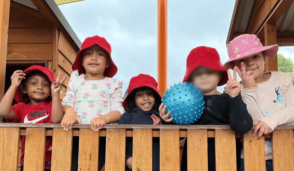 Children smiling from the playground fort at Billy-beet Melton