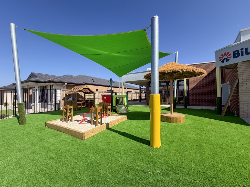 A shaded sandpit and outdoor play area at Billy-beet Wyndham Vale