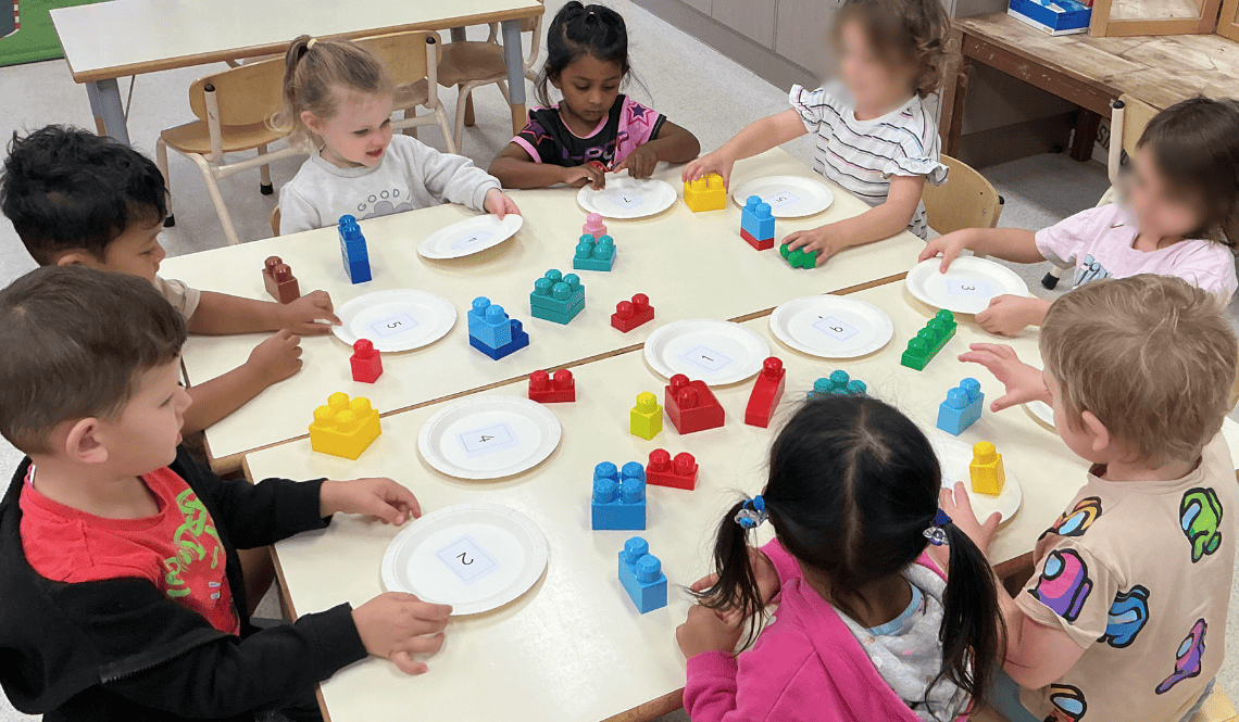 kinder kids playing with blocks for an activity