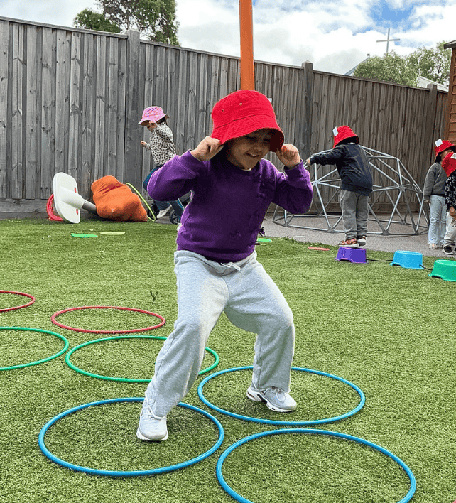 kinder kids jumping with hula hoops during sports buzz