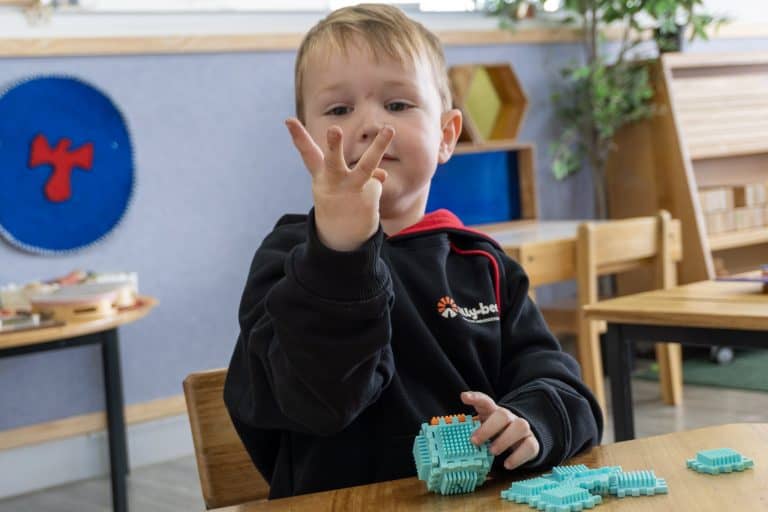 A child working with hands-on Montessori counting materials